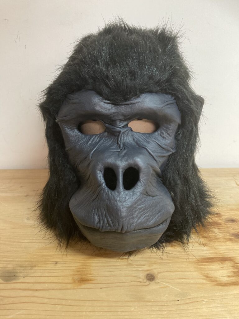 Gros plan du visage d'un masque de gorille réaliste montrant les détails des rides et l'expression animale